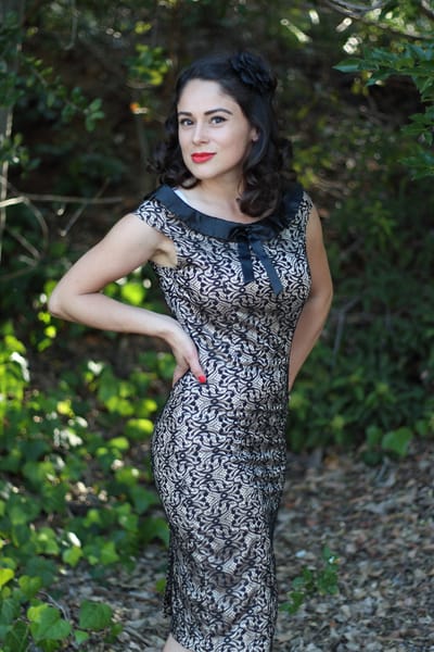 Vintage-inspired outdoor portrait in a black lace dress with a Peter Pan collar